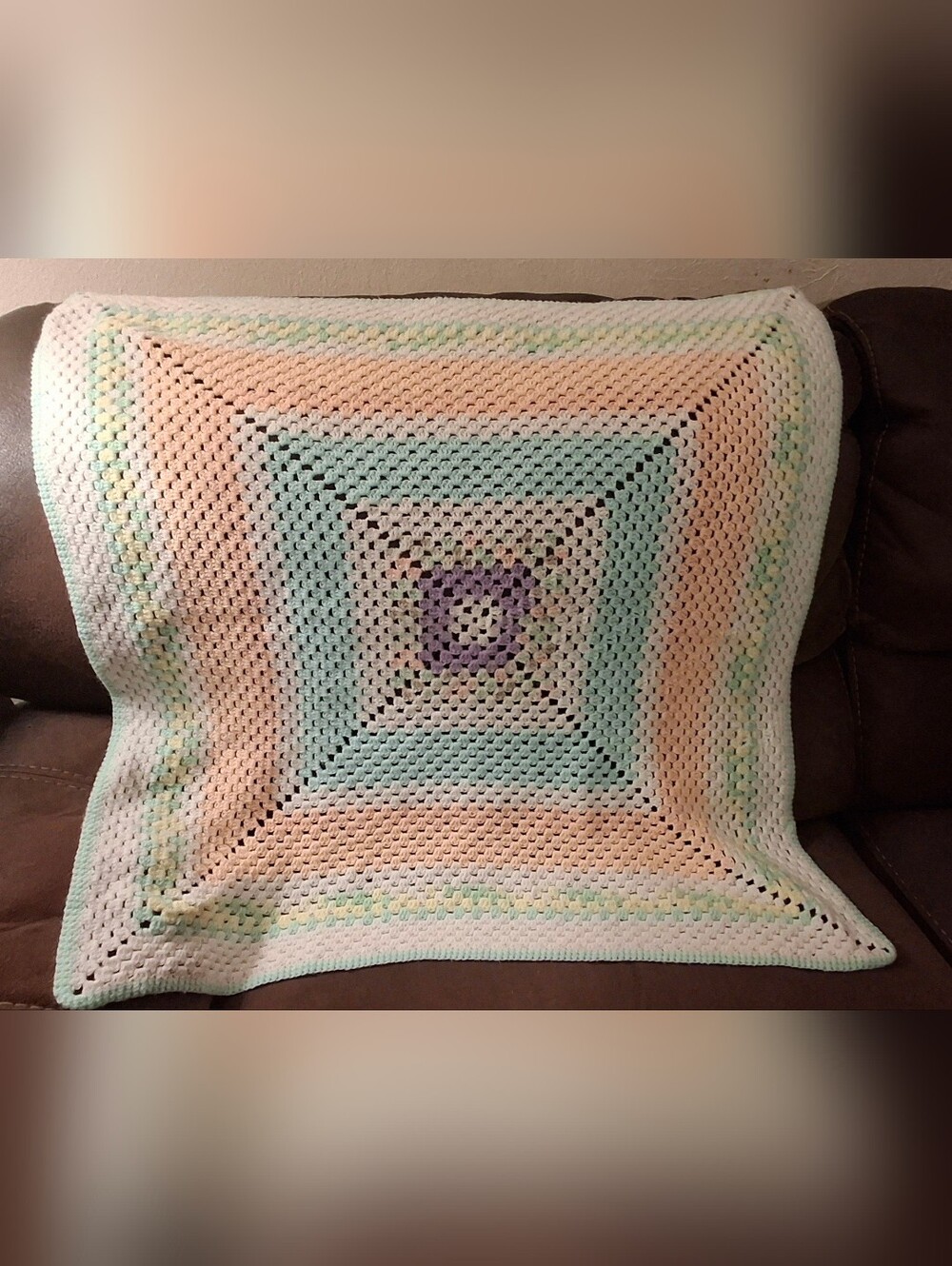 Vintage handmade granny square crochet blanket with a colorful pastel Design